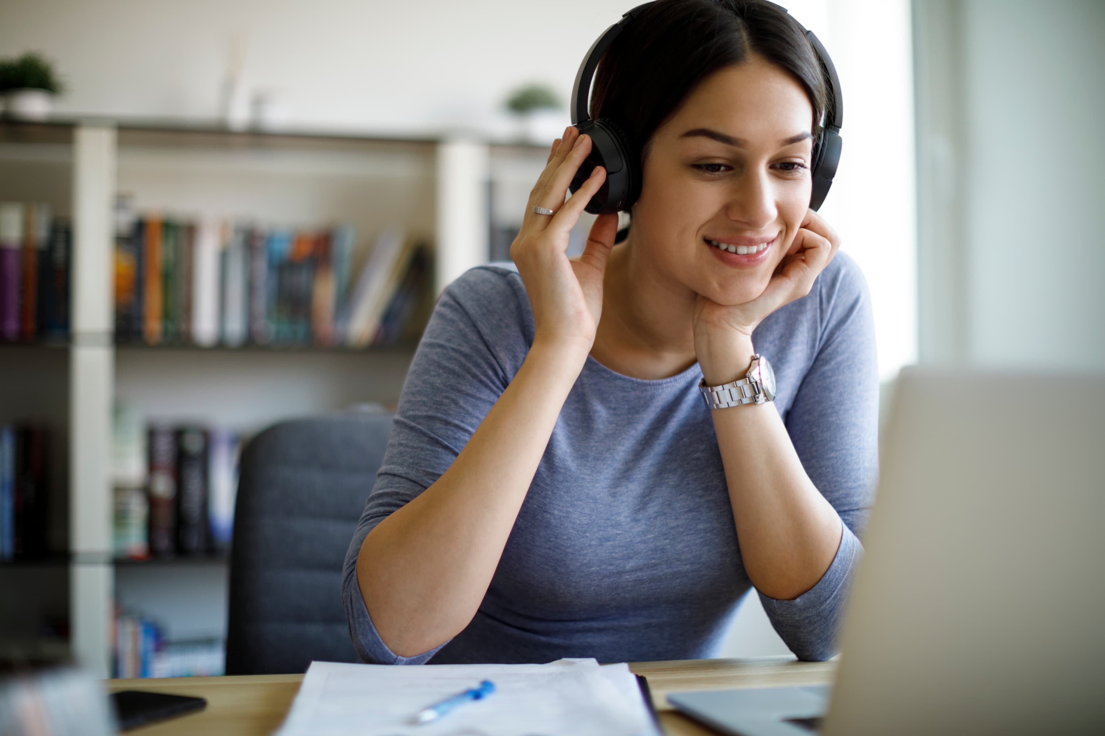 Woman with headphones working from home