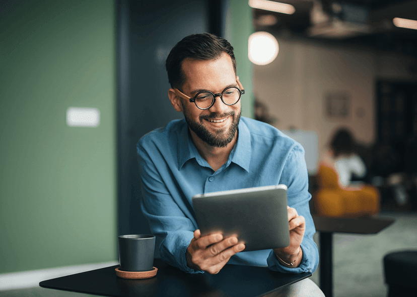 Man holding and looking at tablet